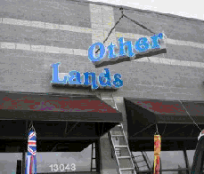 Other Lands sign being removed.